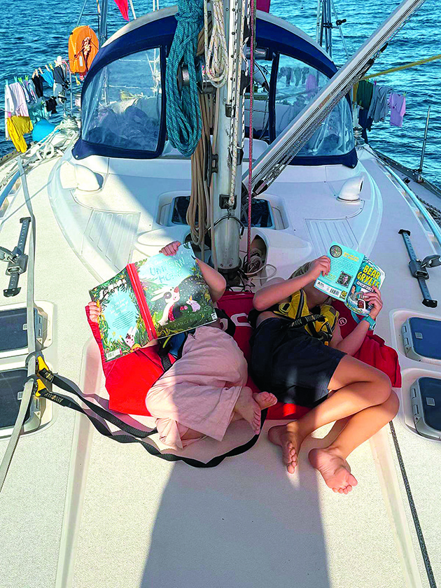 Two children reading on a boat