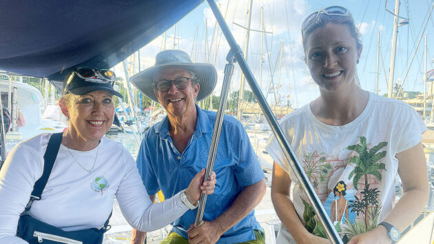 Three people on a yacht after completing a transatlantic crossing