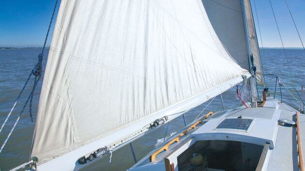An old white sail on a yacht which can cause weather helm