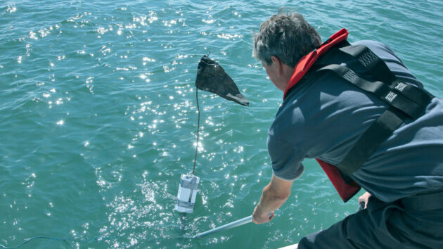 A man trying to untangle a lobster pot mark from a propeller