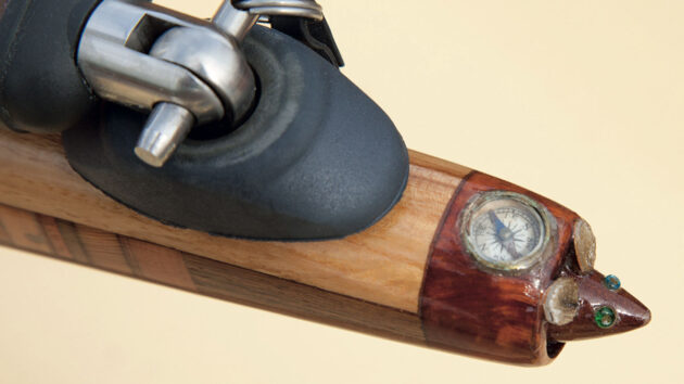 A wooden mouse at the end of a boat tiller on Collective Spirit