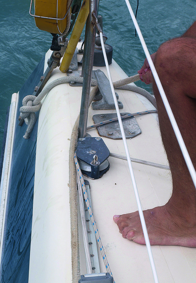 A man tying off a line on a cleat while mooring