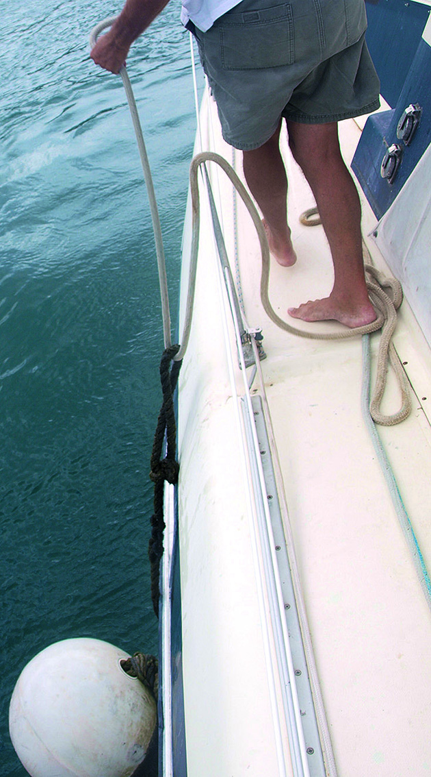a man walking a buoy down a boat