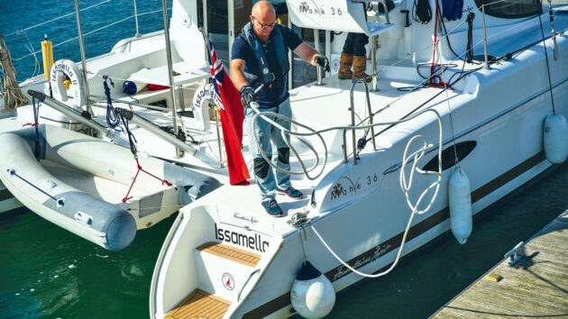 A man preparing lines ahead of mooring a yacht