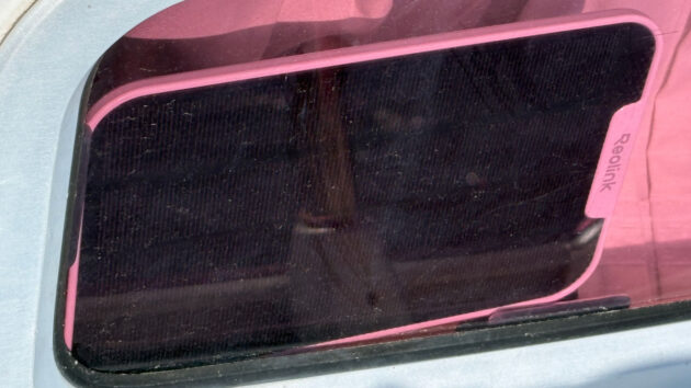 The Reolink solar panel behind the tinted windows of a yacht
