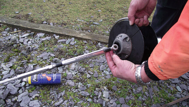A man removing a furler drum