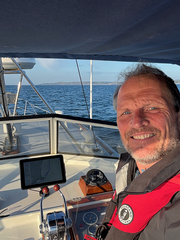 A man driving a motor boat with an orca navigation system