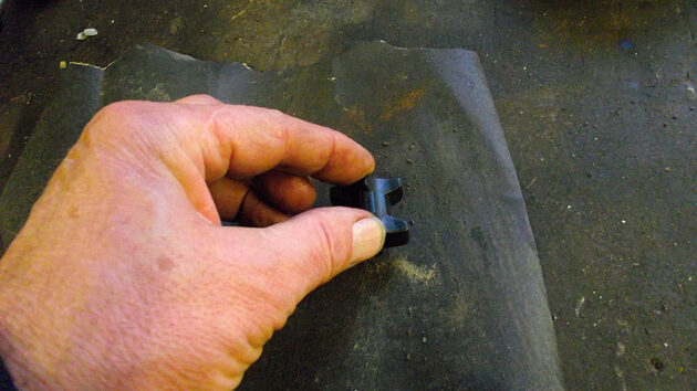 Emery paper being used to dress the outside of plastic bearings