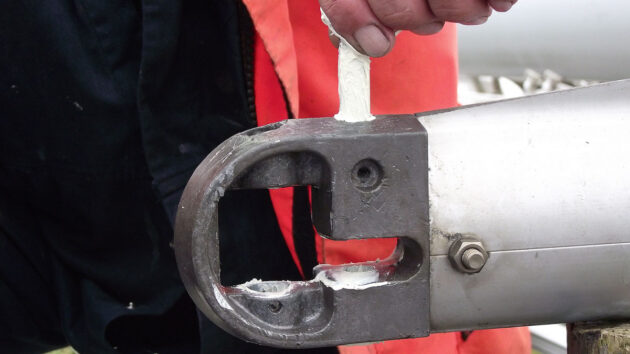 Pins being put back into a mast to secure cap shrouds