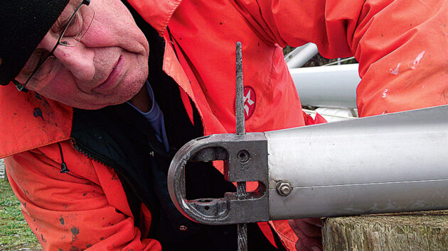 A man looking at the cap shrouds of a mast