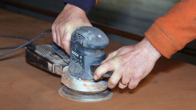 A man sanding wood