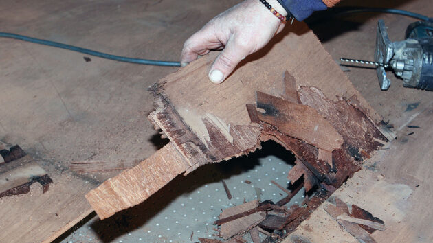 A man patching a coachroof on a boat ahead of epoxy sheathing
