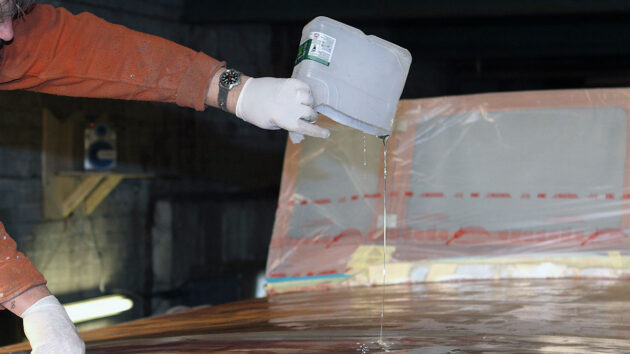 A man pouring resin as part of epoxy sheathing