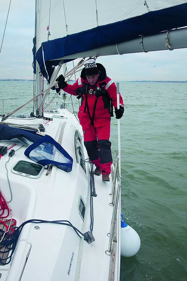 A man with a boat hook on a boat