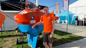 Andrew Bedwell standing next to his 1m boat, Big C v2