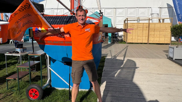 A man standing by a boat
