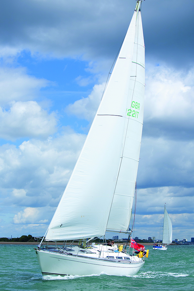 A Sigma 41 sailing under a cloudy sky