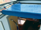 A folded back companionway cover on a boat