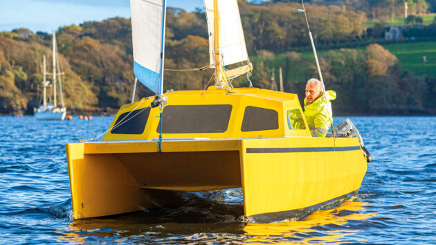 A man sailing a small catamaran