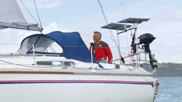 A man helming a yacht