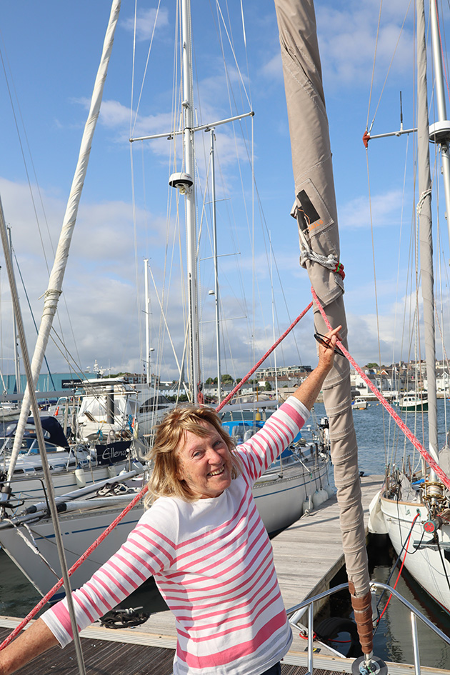 A woman in a pink and white striped jumper on a boat