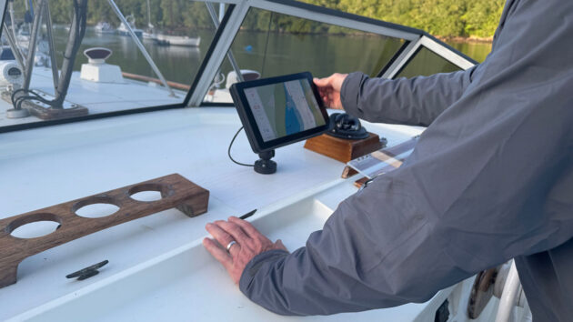 A man using an orca navigation system on his boat