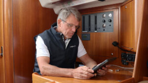 Knut Frostad looking at a tablet on a boat