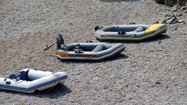 An inflatable tender pulled up on a beach