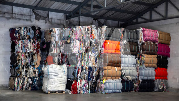 Stacks of sports clothing waste – The global textile industry generates 92 million tonnes of waste every year