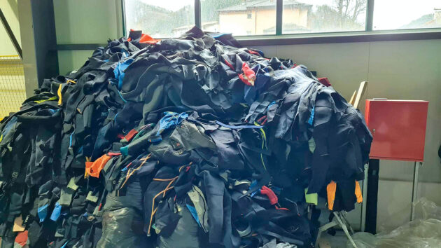 A pile of old neoprene wetsuit sports clothing for reuse. Credit: Circular Flow