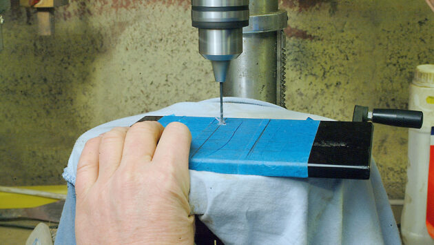 A man making a perspex switch panel for a boat