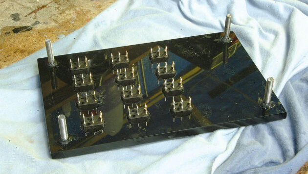 A man making a perspex switch panel for a boat