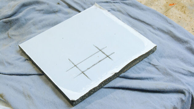 A man making a perspex switch panel for a boat