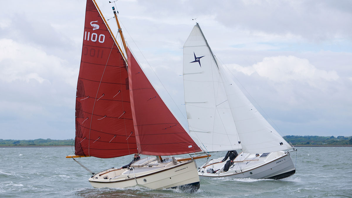 Boat with gaff rigs and boat with Bermudan rig sailing against each other