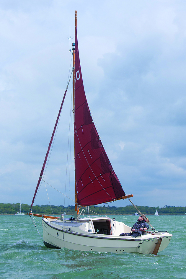 A Shrimper with gaff rigs sailing with red sails