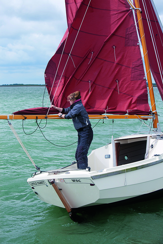 Gaff rigs - a person reefing a main sail