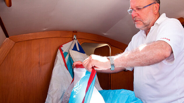 A man showing how to pack a spinnaker