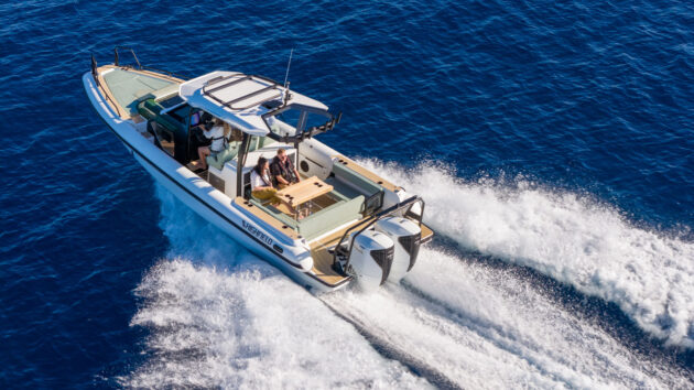 A motorboat being driven across a bay