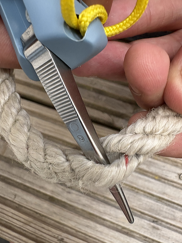 A man using a marlin spike on an Opinel No 9 Ocean Knife
