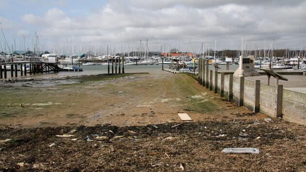 A slipway covered in weed and leading down to the sea
