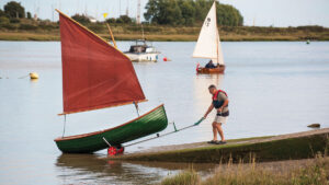 A man dinghy launching from a slipway