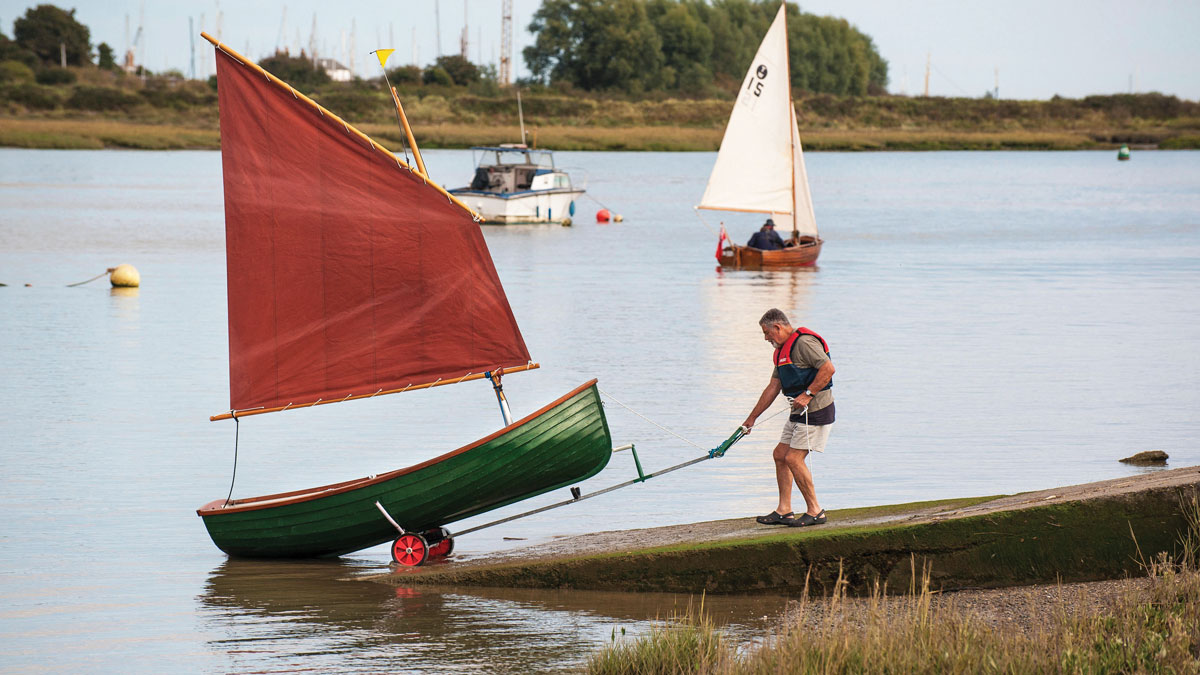 A man dinghy launching from a slipway