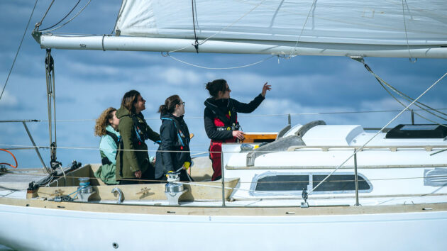 A skipper explaining to crew how to gybe 