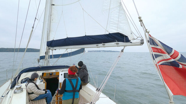 A yacht crew carrying out a gybe