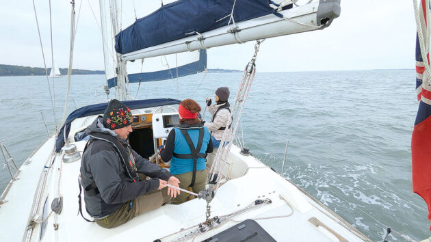 A yacht crew carrying out a gybe