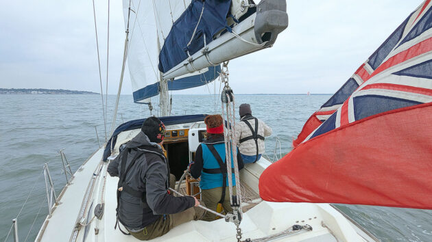 A yacht crew carrying out a gybe