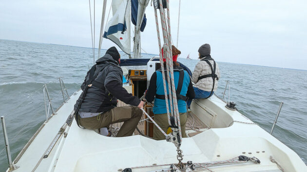 A yacht crew carrying out a gybe