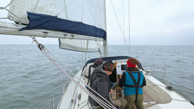 A yacht crew carrying out a gybe