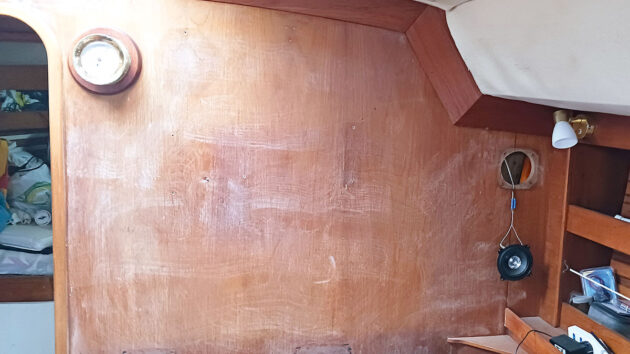 the interior of a boat being prepared ahead of painting over varnished wood