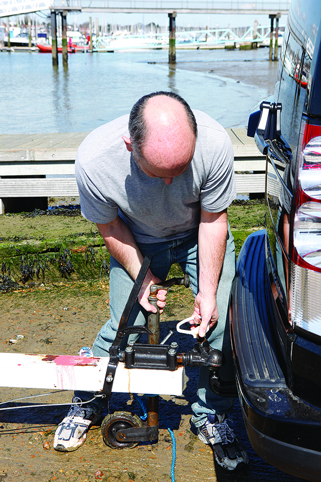 A man attaching a trailer to a suv